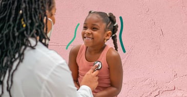Doctor listening to girl's lungs