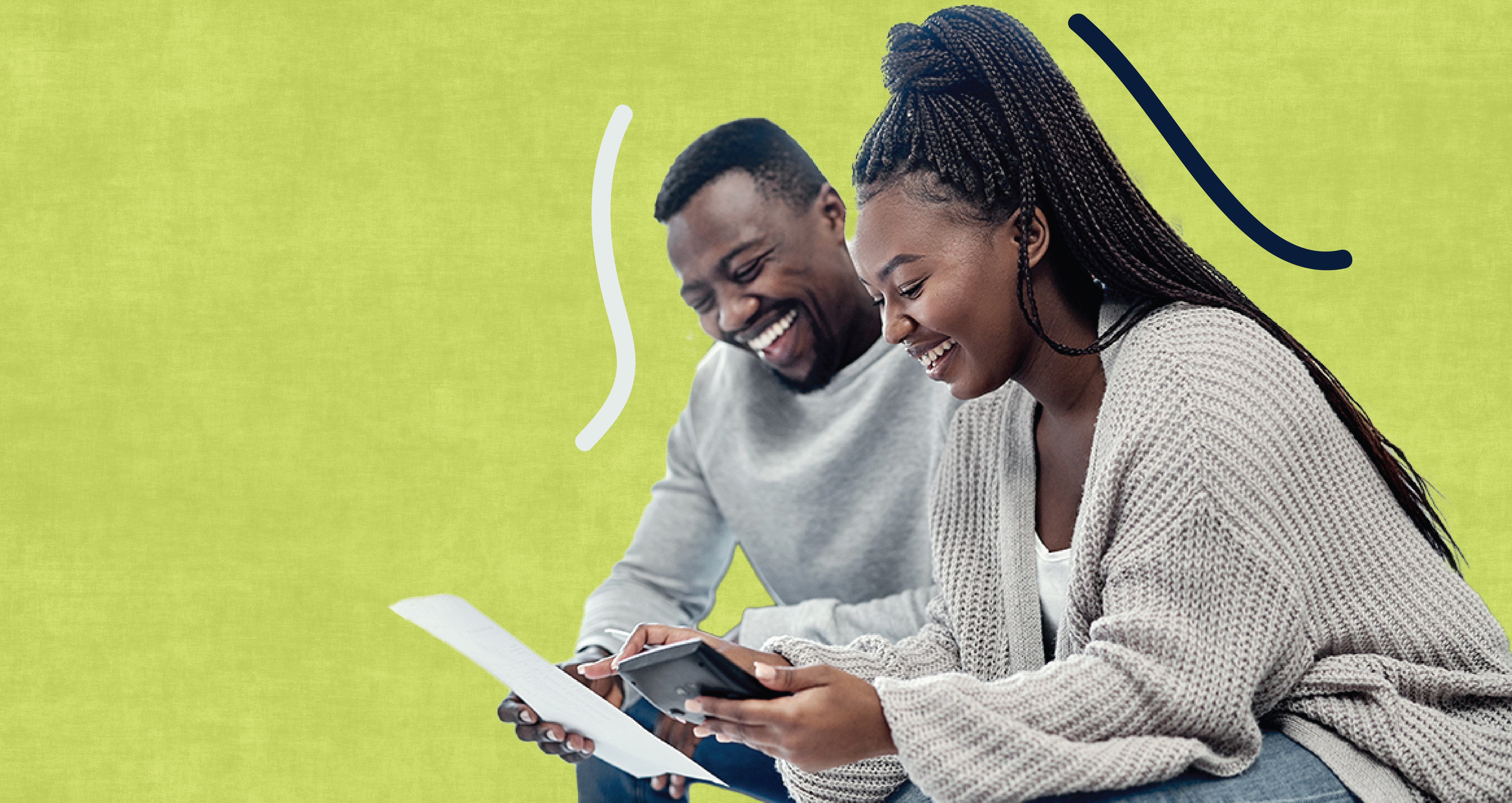 Man and woman smiling, looking at documents. 